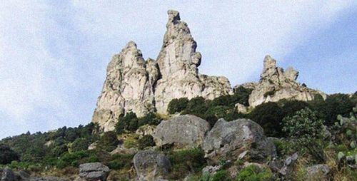 Low angle view of rocky mountains against sky