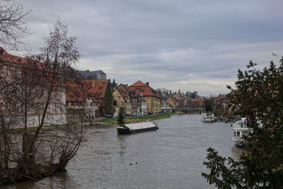 River amidst buildings against sky