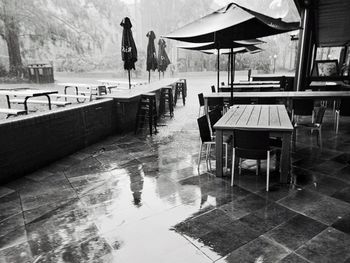 Chairs and tables at restaurant raining 