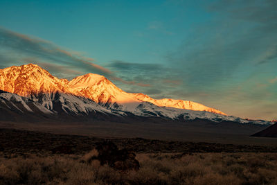 Scenic view of snowcapped mountains against sky during sunset