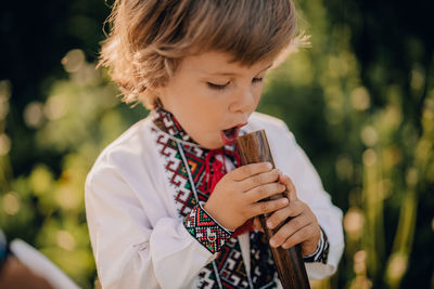 Close-up of boy blowing bubbles