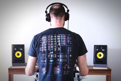 Rear view of dj playing music at home