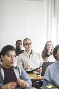 Young man sitting at desk in classroom