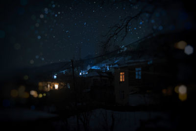 Illuminated buildings against sky at night