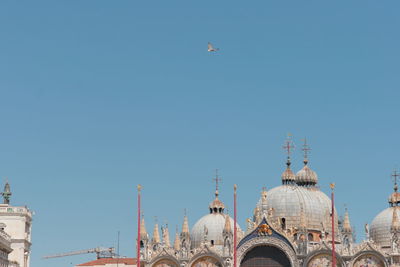 Low angle view of buildings against clear blue sky