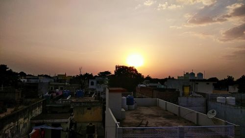 View of town against sky during sunset