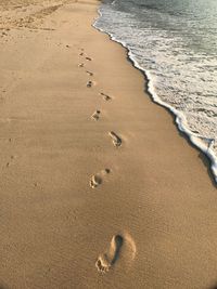 High angle view of footprints on beach