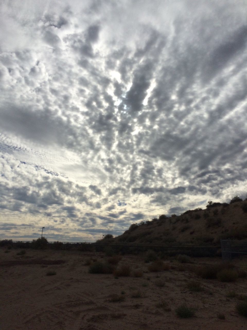 sky, tranquil scene, tranquility, cloud - sky, landscape, cloudy, scenics, beauty in nature, nature, cloud, mountain, non-urban scene, remote, overcast, idyllic, horizon over land, day, outdoors, mountain range, no people