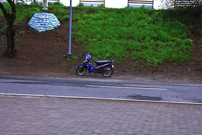 Person riding motor scooter on road