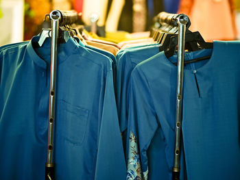 Close-up of clothes hanging on rack in store