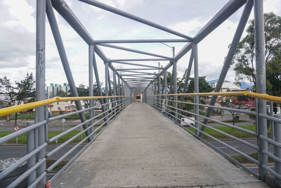 Bridge over footbridge against sky