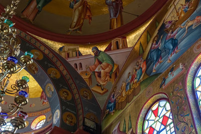 Low angle view of ornate ceiling in temple