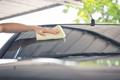 A wipe clean the car with cloth and polishing waxing cream