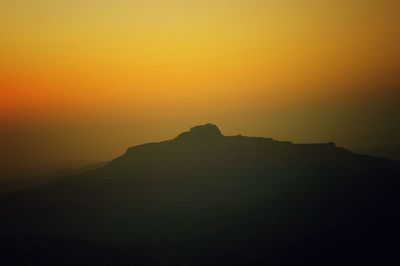 Scenic view of silhouette mountain against sky during sunset