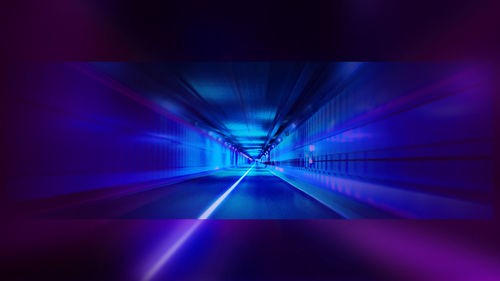 Illuminated tunnel at night