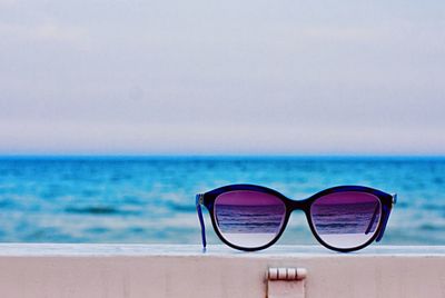 Close-up of sunglasses on beach