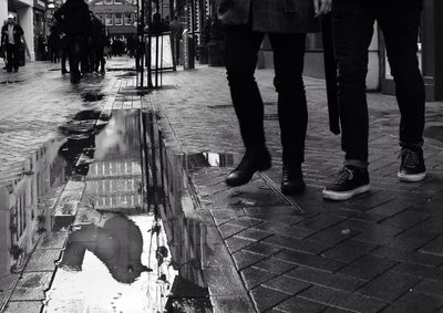 Woman standing on footpath