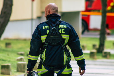 Rear view of men standing outdoors