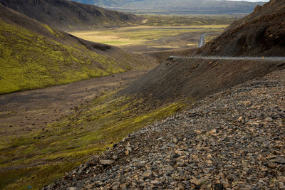 Icelandic road through lava fields and green moss. travel freedom concept