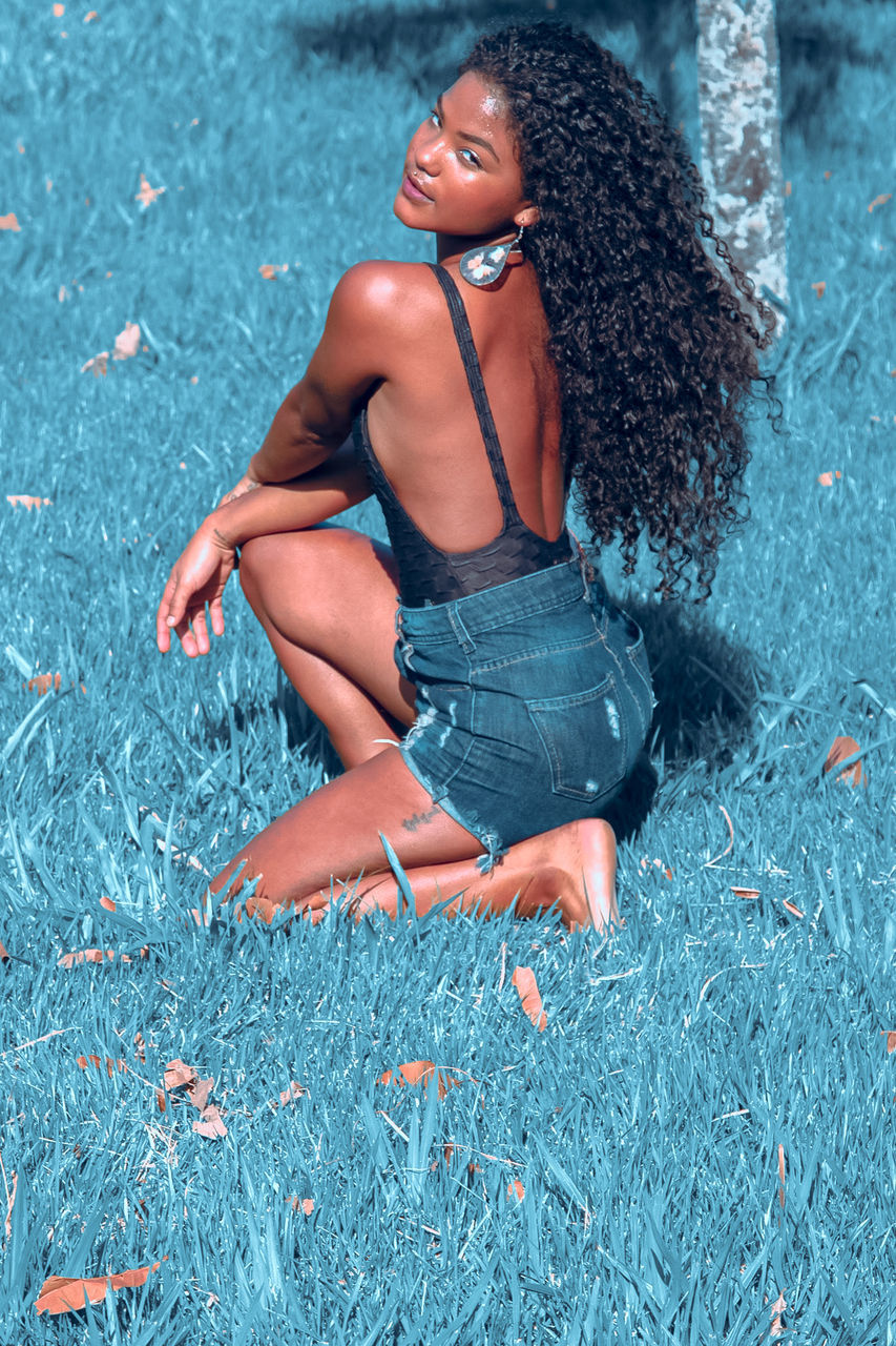 blue, one person, women, adult, young adult, hairstyle, clothing, photo shoot, person, lifestyles, female, nature, fashion, full length, portrait, long hair, relaxation, casual clothing, human hair, leisure activity, sitting, outdoors, looking, emotion, human leg, day