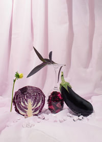 Eggplant and purple cabbage against light violet background. healthy food concept. still life