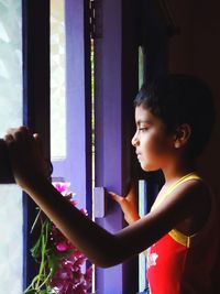 Side view of a boy looking away at home