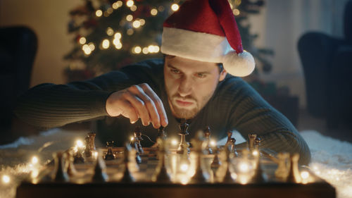 Boy plays chess on christmas mood