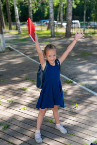 Full length portrait of boy standing on footpath