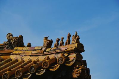 Low angle view of statue against clear blue sky