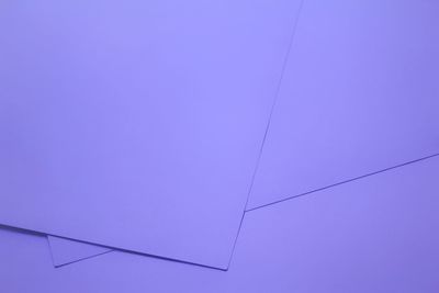 High angle view of papers on purple background