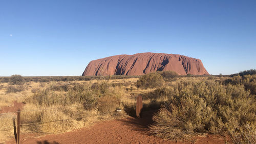 Scenic view of desert against clear blue sky