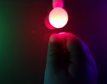 Close-up of hand holding illuminated light