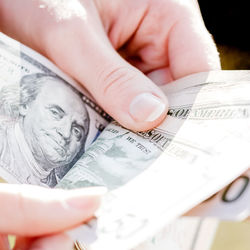 Cropped hand of person holding paper currency