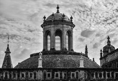 Low angle view of historical building against cloudy sky