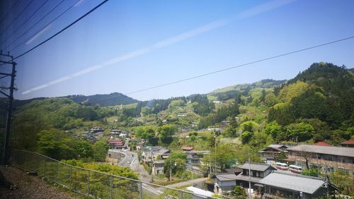 High angle view of buildings and trees against sky