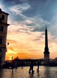 Silhouette of building against cloudy sky