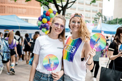 Portrait of smiling young women standing outdoors