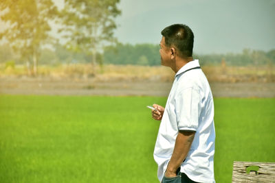 Side view of man standing on field