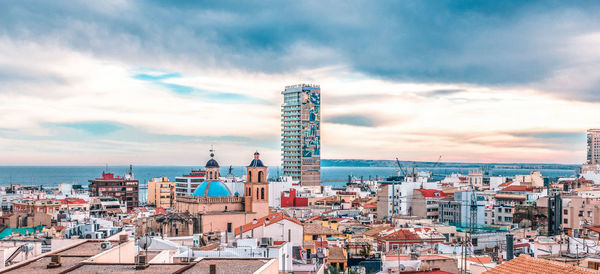 High angle view of city against cloudy sky