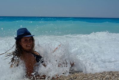 Portrait of smiling woman enjoying in sea