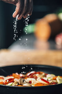 Close-up of chef preparing food in kitchen