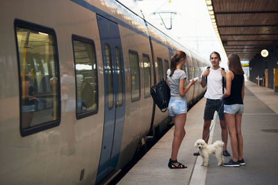 Friends on train station