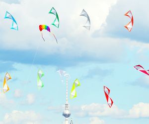 Low angle view of kite flying against cloudy sky