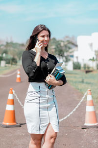 Young woman using mobile phone in city