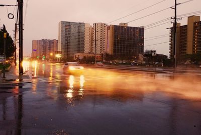 City street by buildings during rainy season