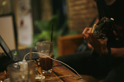 Reflection of man photographing on table