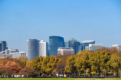 Buildings in city against clear sky