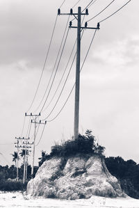 Low angle view of electricity pylon against sky