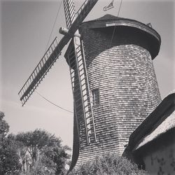 Low angle view of windmill against sky