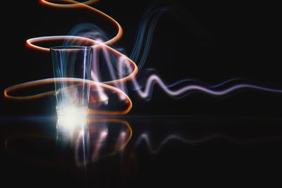 Close-up of light trails over black background